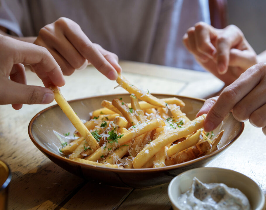 friends-sharing a bowl of french fries