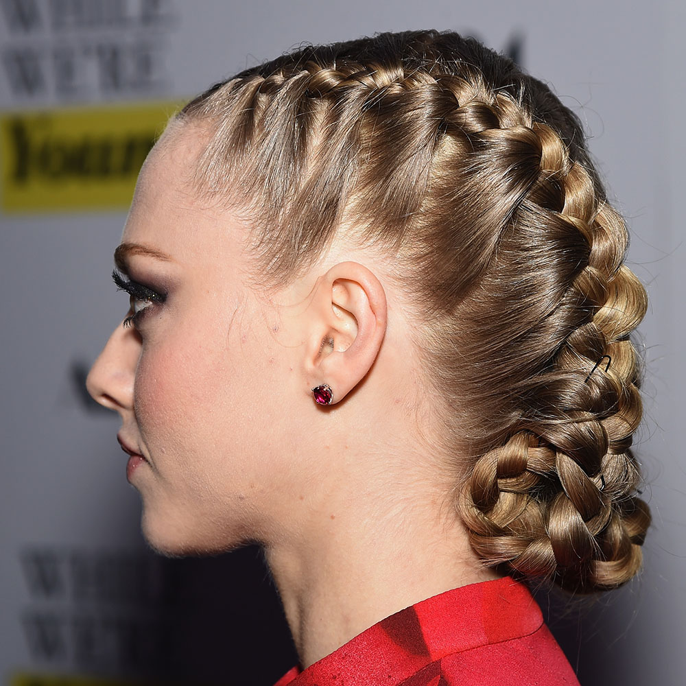 Side view of Amanda Seyfried wearing tucked French braids