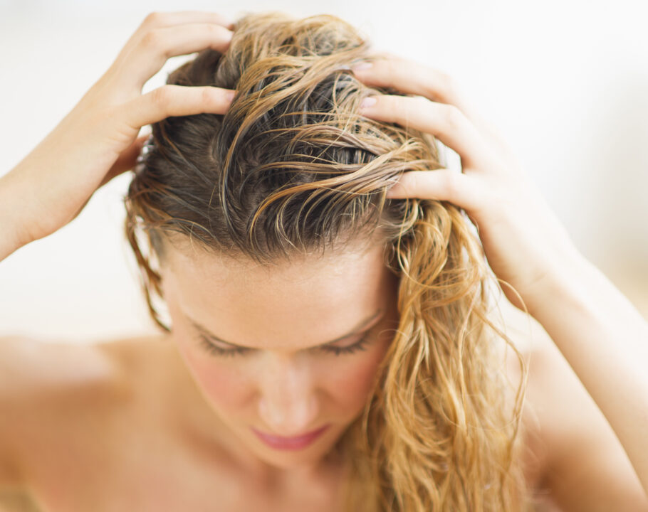 woman touching hair and scalp